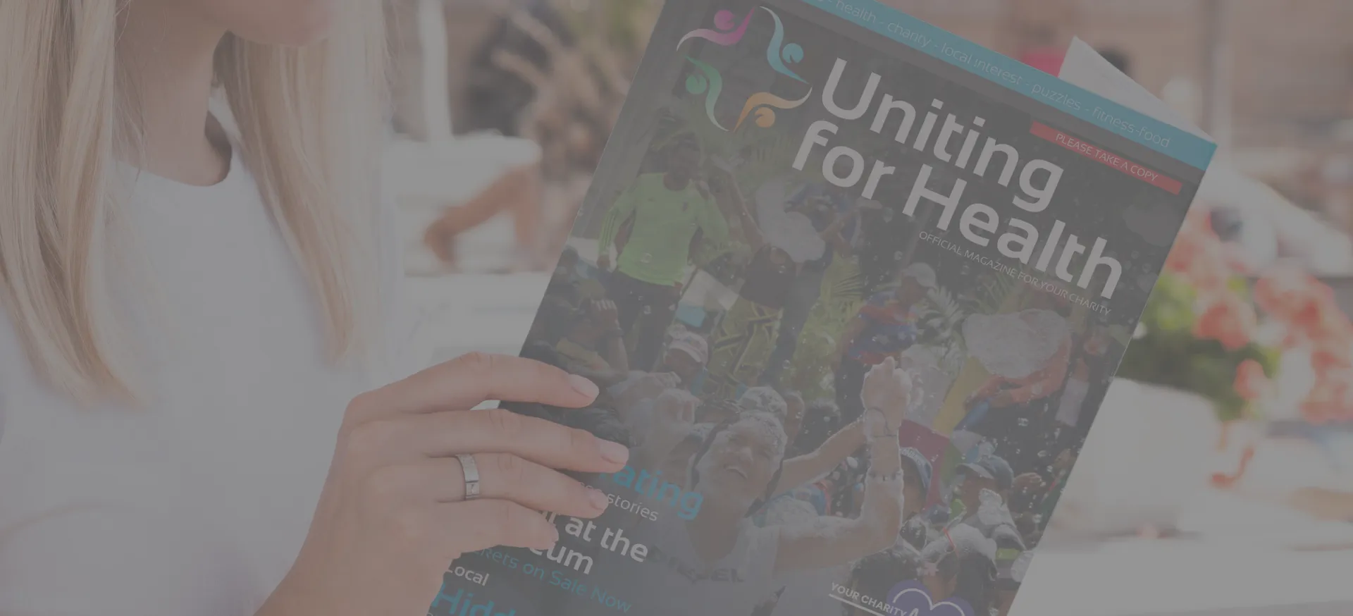 A reader with the Uniting For Health magazine