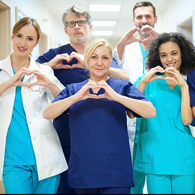 NHS staff making heart shapes with their hands