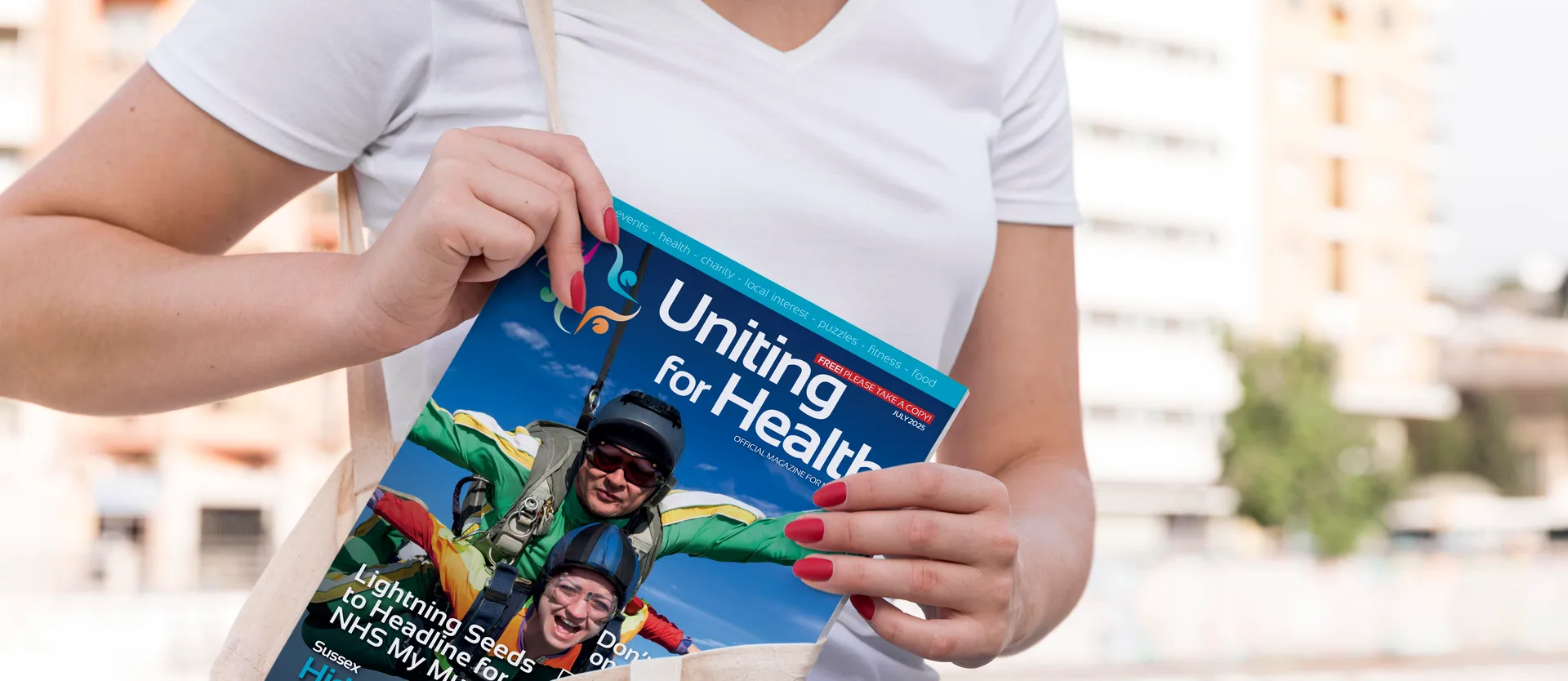 Hands holding the Uniting For Health magazine